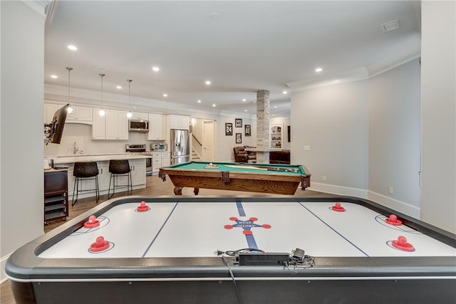 rec room featuring ornamental molding, hardwood / wood-style floors, sink, decorative columns, and billiards