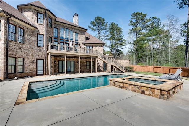 view of swimming pool with an in ground hot tub and a patio area