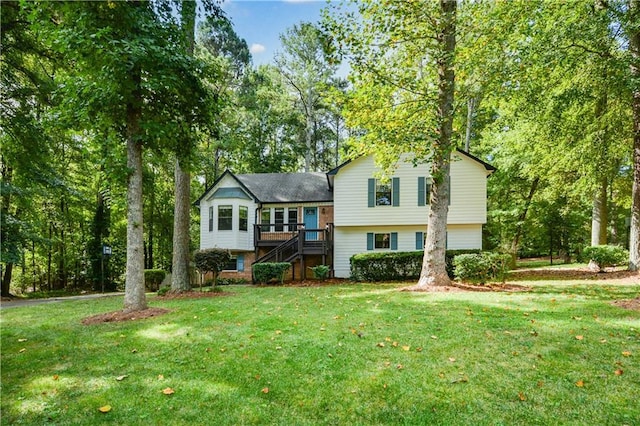 tri-level home with a deck and a front lawn