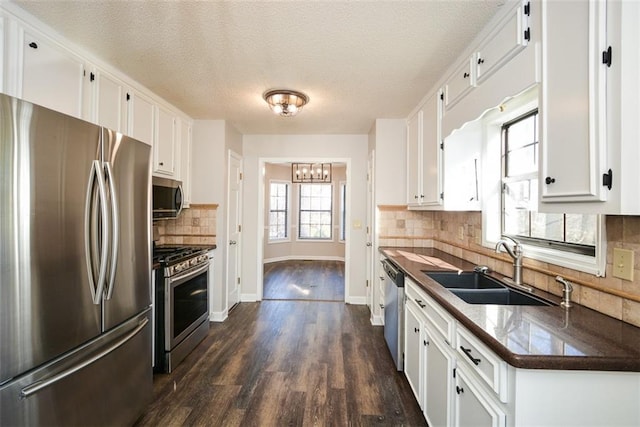 kitchen featuring sink, white cabinetry, and appliances with stainless steel finishes