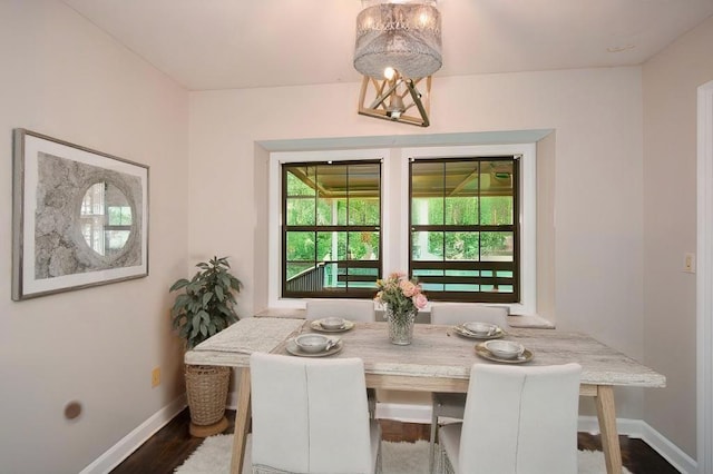 dining space with dark wood-type flooring