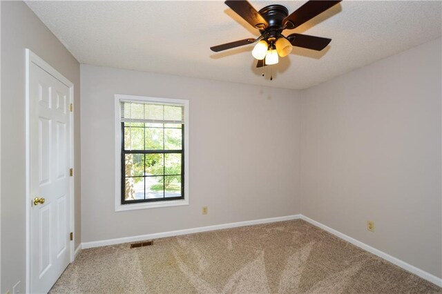 empty room featuring ceiling fan and carpet flooring