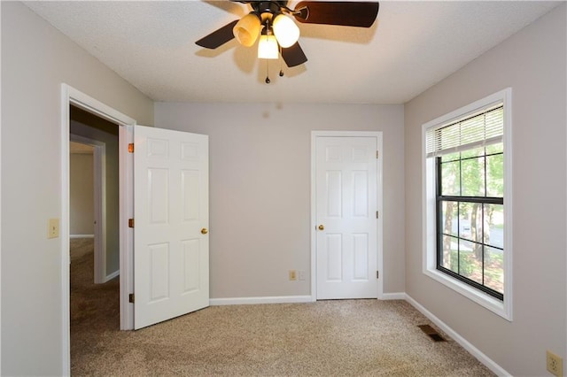 unfurnished bedroom with ceiling fan and carpet flooring