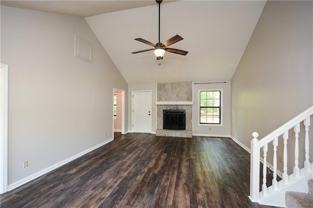 unfurnished living room featuring high vaulted ceiling, a fireplace, ceiling fan, and dark hardwood / wood-style floors