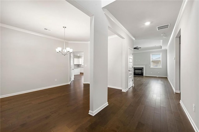 hall featuring crown molding, a notable chandelier, and dark hardwood / wood-style floors