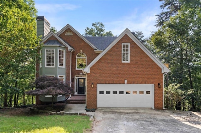 184 Corner Oak Ct, Waleska, GA 30183 - traditional-style house featuring an attached garage, concrete driveway, a chimney, and brick siding
