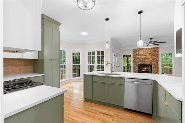 184 Corner Oak Ct, Waleska, GA 30183 - kitchen featuring green cabinets, stainless steel dishwasher, a fireplace, a ceiling fan, and cooktop