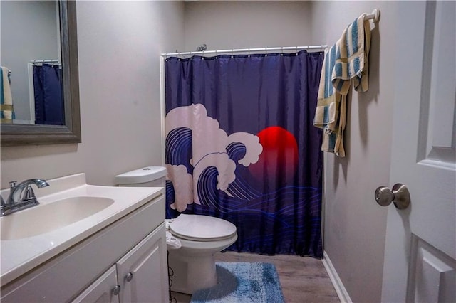 full bathroom with curtained shower, baseboards, toilet, wood finished floors, and vanity