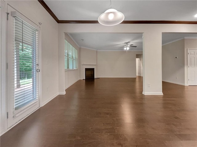 unfurnished living room featuring ornamental molding, a fireplace, wood finished floors, and a wealth of natural light