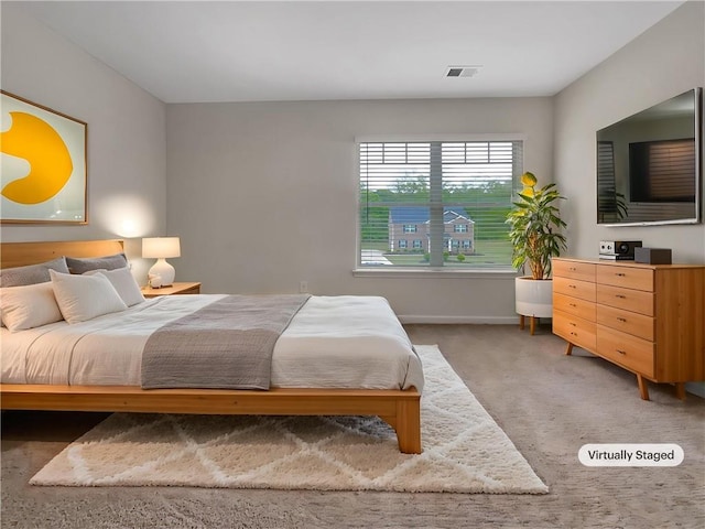 bedroom with baseboards, carpet, and visible vents
