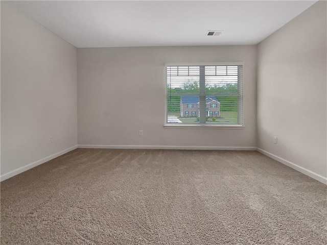 carpeted empty room with baseboards and visible vents