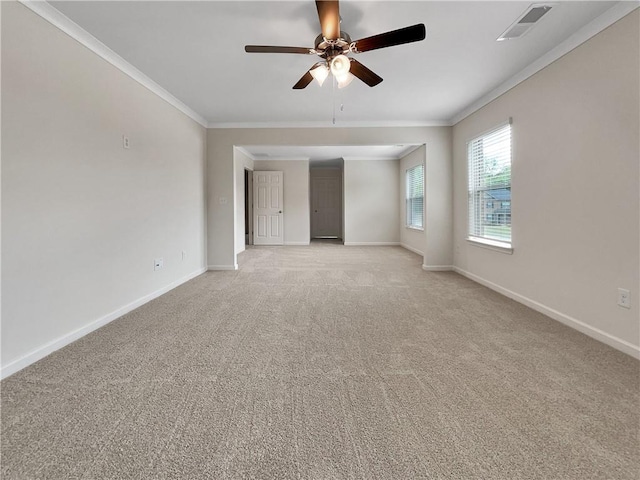 empty room with baseboards, ceiling fan, ornamental molding, and light carpet