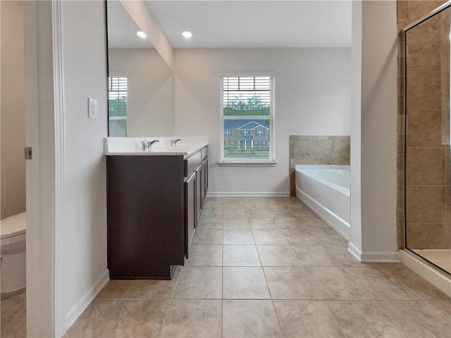 full bath with vanity, a shower stall, and plenty of natural light