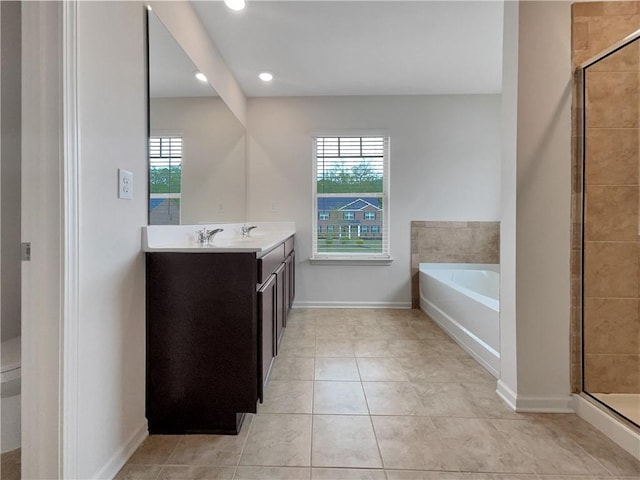 bathroom with vanity, tile patterned floors, a bath, and a shower stall