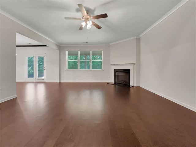 unfurnished living room with crown molding, ceiling fan, a glass covered fireplace, and wood finished floors