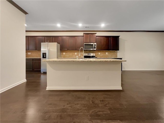 kitchen with ornamental molding, decorative backsplash, recessed lighting, a sink, and stainless steel appliances