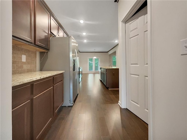 kitchen with dark brown cabinetry, tasteful backsplash, stainless steel fridge with ice dispenser, dark wood-style floors, and recessed lighting
