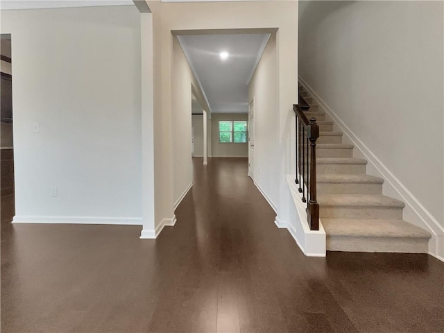 stairs featuring baseboards and wood finished floors