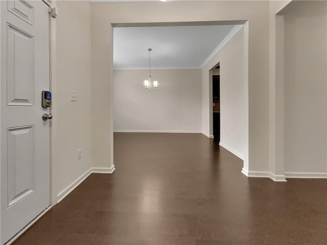 foyer entrance featuring crown molding and baseboards