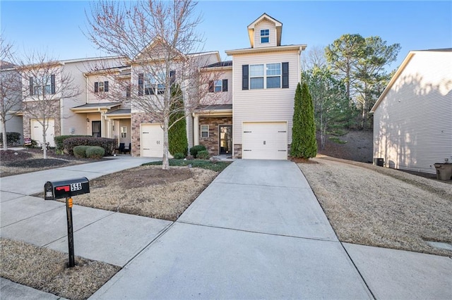 view of property featuring a garage and concrete driveway