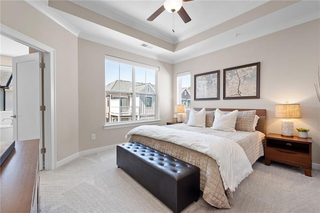 bedroom featuring visible vents, baseboards, a tray ceiling, ornamental molding, and light carpet