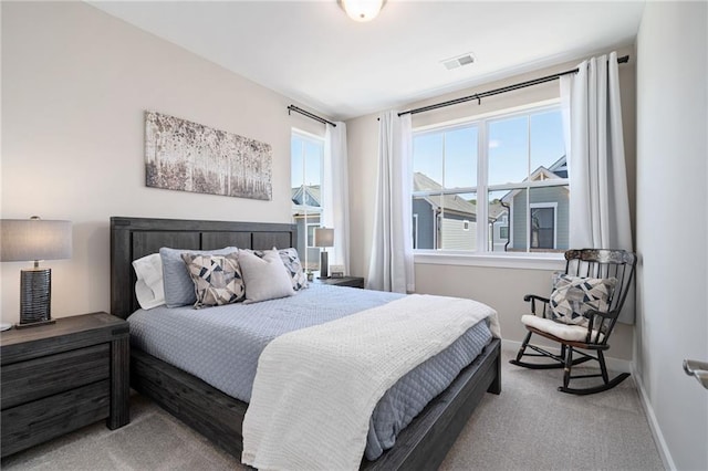 bedroom with carpet flooring, visible vents, and baseboards