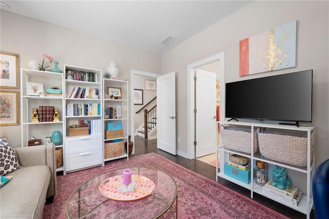 sitting room featuring stairway, wood finished floors, visible vents, and baseboards