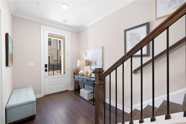 entryway featuring stairway, visible vents, baseboards, and wood finished floors