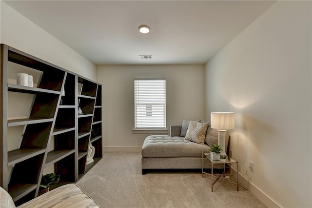 sitting room featuring light carpet