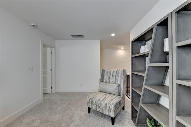 sitting room featuring light colored carpet