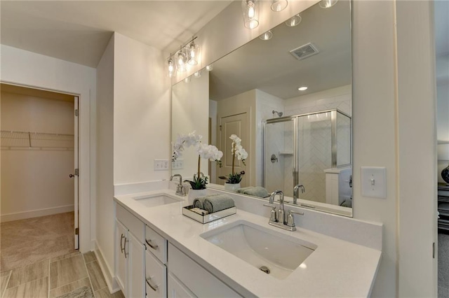 bathroom featuring vanity and a shower with shower door