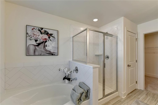 bathroom with shower with separate bathtub