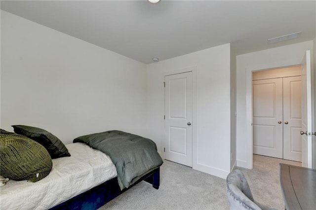 bedroom featuring light colored carpet