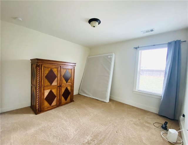 bedroom with carpet floors, visible vents, and baseboards