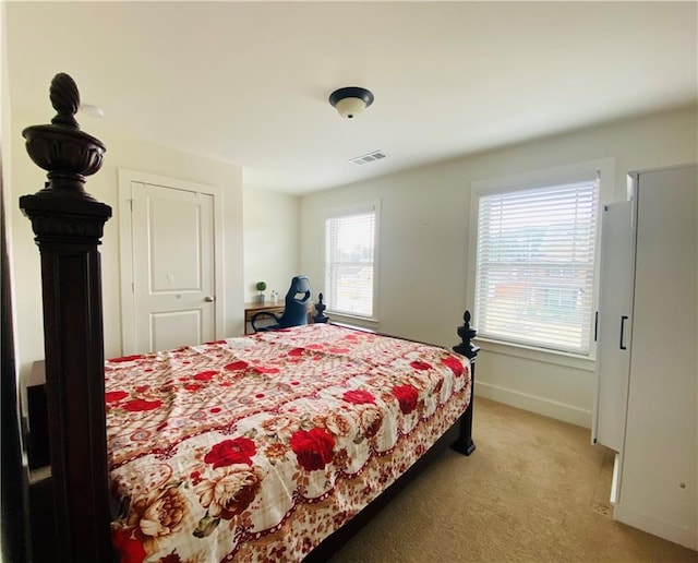 bedroom featuring light carpet, visible vents, and baseboards