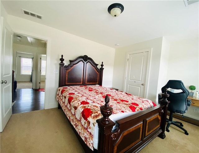 bedroom featuring carpet flooring, visible vents, and attic access