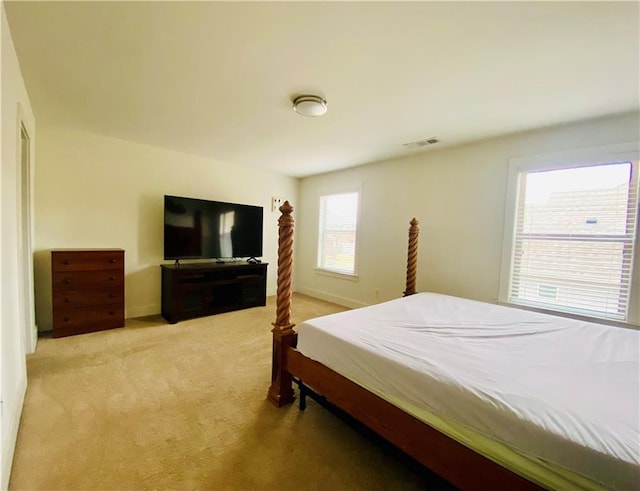 bedroom featuring light carpet, baseboards, and visible vents