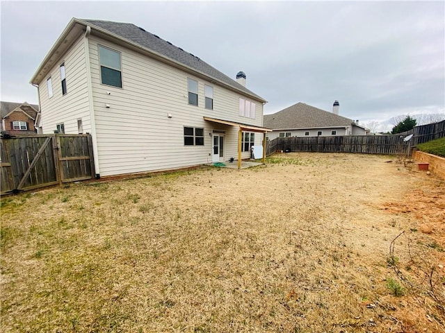 back of house featuring a fenced backyard