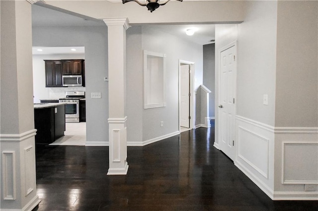 interior space featuring dark hardwood / wood-style floors and ornate columns