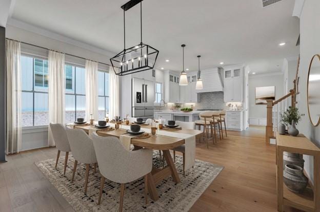 dining space featuring stairway, recessed lighting, light wood-style floors, and ornamental molding