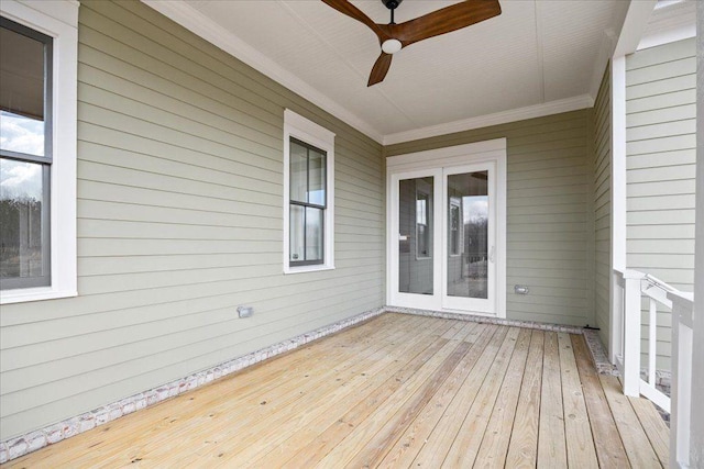 wooden deck with a ceiling fan