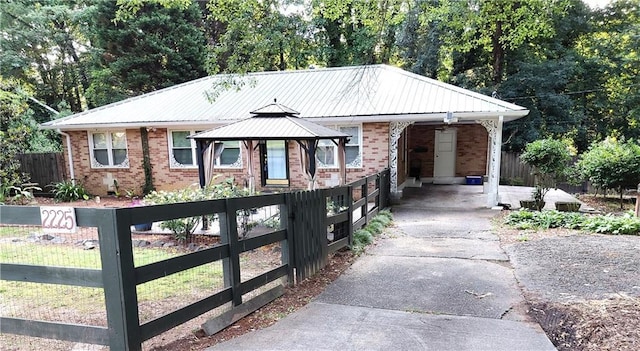 2225 Harold Ln SE, Smyrna, GA 30080 - view of front of house with driveway, brick siding, a gazebo, and an attached carport