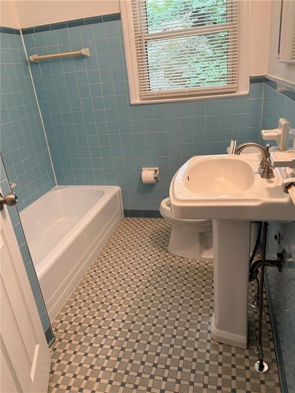 2225 Harold Ln SE, Smyrna, GA 30080 - full bathroom featuring tile walls, a wainscoted wall, toilet, and tile patterned floors