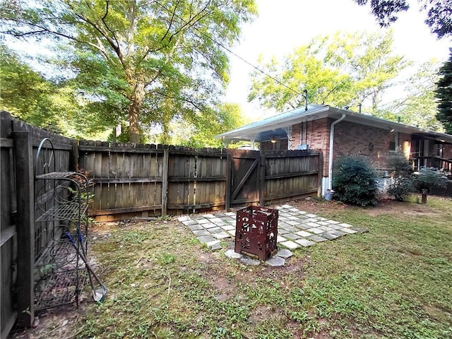 2225 Harold Ln SE, Smyrna, GA 30080 - fenced backyard featuring a gate and a patio area
