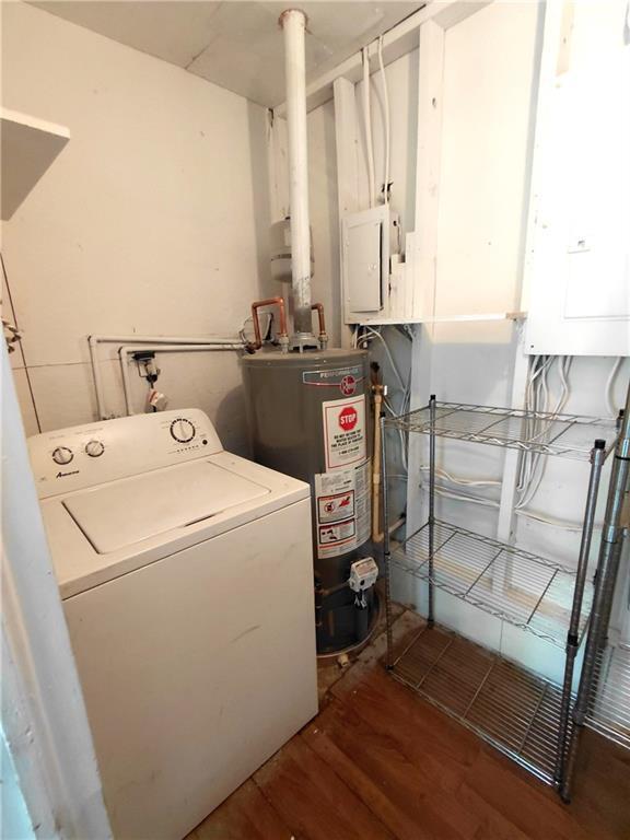 2225 Harold Ln SE, Smyrna, GA 30080 - laundry room featuring washer / clothes dryer, gas water heater, wood finished floors, and electric panel