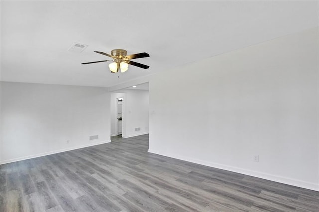 empty room with hardwood / wood-style floors and ceiling fan