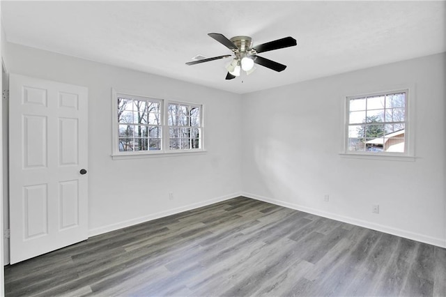 spare room with ceiling fan, baseboards, and wood finished floors