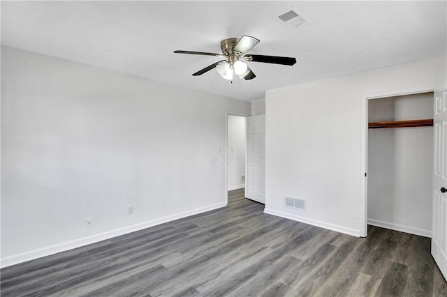 unfurnished bedroom featuring dark wood-type flooring, ceiling fan, and a closet