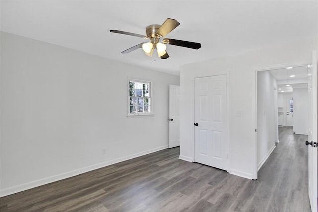 unfurnished bedroom with ceiling fan, baseboards, and wood finished floors