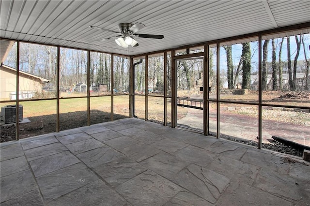 unfurnished sunroom featuring ceiling fan